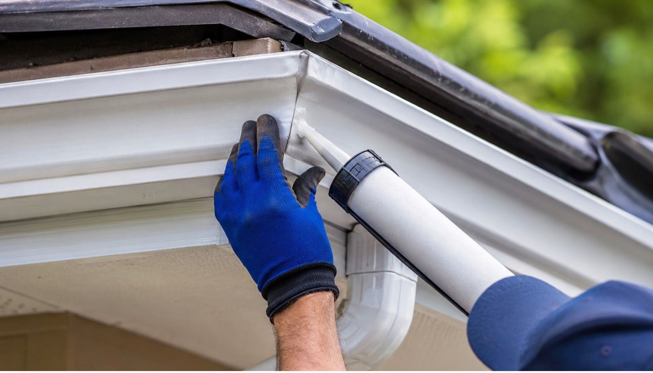 A gutter joint being inspected and repaired